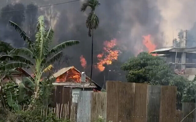 A video still of smoke rising from burning houses in Manipur, India, Sunday, May 28, 2023. (AP Photo/Paojel Chaoba)