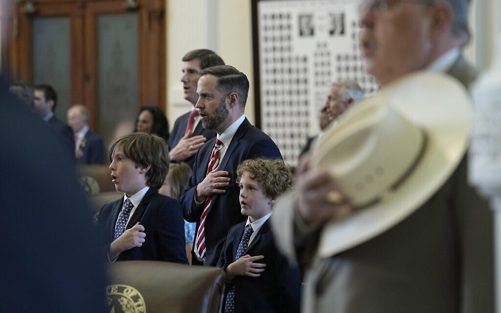 Illustrative: Texas state Rep. Dustin Burrows, R-Lubbock, center, is joined by his sons, David and Whitby, during the Pledge of Allegiance in the House Chamber at the Texas Capitol on the last day of the legislative session in Austin, Texas, May 29, 2023. (AP Photo/Eric Gay)