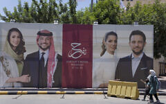 A poster with pictures of Crown Prince Hussein and his fiancee, Saudi architect Rajwa Alseif is posted at a road in Amman, Jordan, May 31, 2023. (Nasser Nasser/AP)