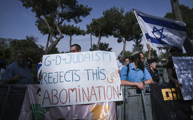 Israeli right-wing activists hold banners and wave the national flag, protesting against the annual Pride parade in Jerusalem, Thursday, June 1, 2023. (AP Photo/Mahmoud Illean)