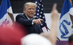 US former president Donald Trump visits with campaign volunteers at the Grimes Community Complex Park, Thursday, June 1, 2023, in Des Moines, Iowa. (AP Photo/Charlie Neibergall)