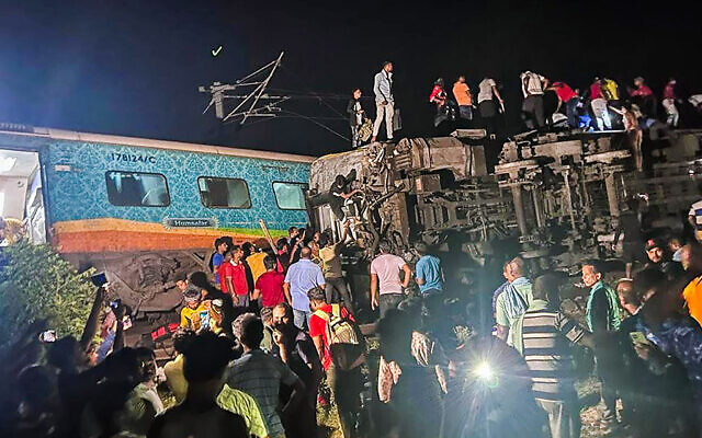 Rescuers work at the site of passenger trains that derailed in Balasore district, in the eastern Indian state of Orissa, Friday, June 2, 2023. Two passenger trains derailed in India, killing at least 200 and trapping hundreds of others inside more than a dozen damaged coaches, officials said. (Press Trust of India via AP)