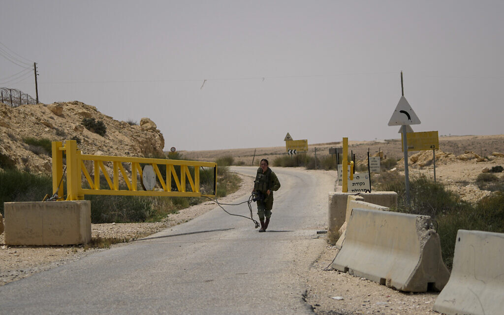 An Israeli soldier closes a gate leading to the Egyptian border in southern Israel, following a shooting attack on June 3, 2023. (AP/Tsafrir Abayov)