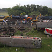 Workers at the site of a deadly train derailment, in Balasore district, in the eastern Indian state of Orissa, June 4, 2023. (AP Photo/Rafiq Maqbool)