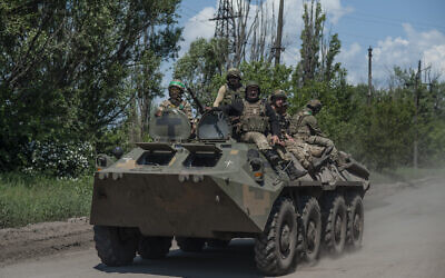 Ukrainian soldiers ride an APC on the frontline near Bakhmut, the site of fierce battles with the Russian troops in the Donetsk region, Ukraine, Monday, June 5, 2023. (Iryna Rybakova via AP)