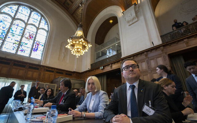 Ukraine's delegation with ambassador-at-large of the ministry of foreign affairs Anton Korynevych, right, and director general of international law of the ministry of foreign affairs Oksana Zolotaryova, second right, wait for judges to enter the World Court in The Hague, Netherlands, June 6, 2023. (AP Photo/Peter Dejong)