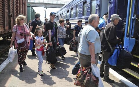 People board an evacuation train at a railway station in Kherson, Ukraine, June 6, 2023, after the destruction of a major dam and hydroelectric power station in a part of southern Ukraine. (AP Photo/Nina Lyashonok)