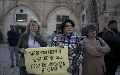 Members of the Armenian community protest a contentious deal to hand over a large section of the Armenian Quarter in the Old City of Jerusalem for a hotel project, May 19, 2023. (Maya Alleruzzo/AP)