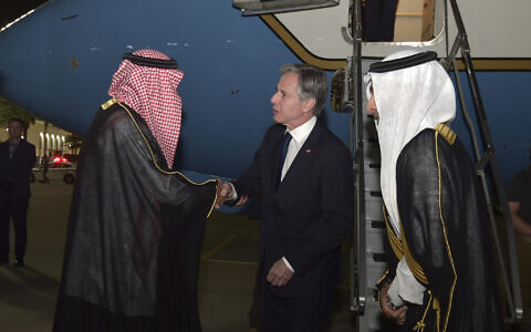 US Secretary of State Antony Blinken, center, shakes hands with a Saudi official upon his arrival, in Jedda, Saudi Arabia, June 6, 2023.  (Amer Hilabi/Pool via AP)