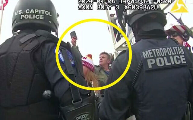This image from Washington Metropolitan Police Department body-worn video, released and annotated by the Justice Department in the statement of facts supporting an arrest warrant for Jay James Johnston, shows Johnston, circled in yellow, at the US Capitol on January 6, 2021, in Washington. (Justice Department via AP)