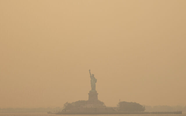 The Statue of Liberty, covered in a haze-filled sky, is photographed from the Staten Island Ferry, Wednesday, June 7, 2023, in New York. (AP Photo/Yuki Iwamura)
