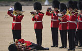 A trombone player in the military band faints during the Colonel's Review, the final rehearsal of the Trooping the Colour, the King's annual birthday parade, at Horse Guards Parade in London, June 10, 2023. (Jonathan Brady/PA via AP)