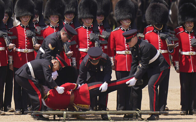 A soldier is carried out on a stretcher after fainting during the Colonel's Review, the final rehearsal of the Trooping the Colour, the King's annual birthday parade, at Horse Guards Parade in London, June 10, 2023. (AP Photo/Alberto Pezzali)