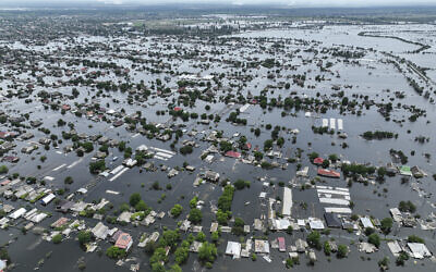 Houses are seen underwater in the flooded town of Oleshky, Ukraine, June 10, 2023. (AP Photo)