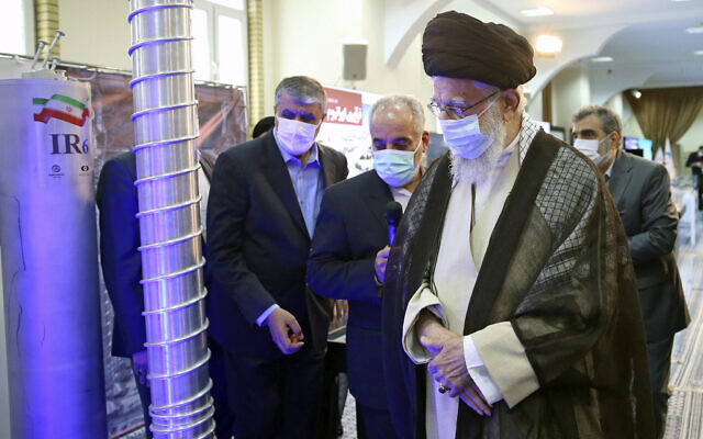 Iranian Supreme Leader Ayatollah Ali Khamenei, right, visits an exhibition of Iran's nuclear achievements, at his office compound in Tehran, Iran, June 11, 2023. (Office of the Iranian Supreme Leader, Via AP)