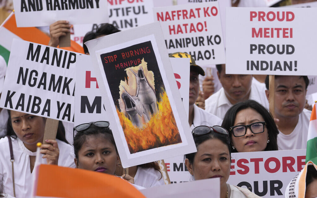 Members of Manipur's Meitei community hold placards during a peace rally in Mumbai, India, June 17, 2023. (AP Photo/Rajanish Kakade)