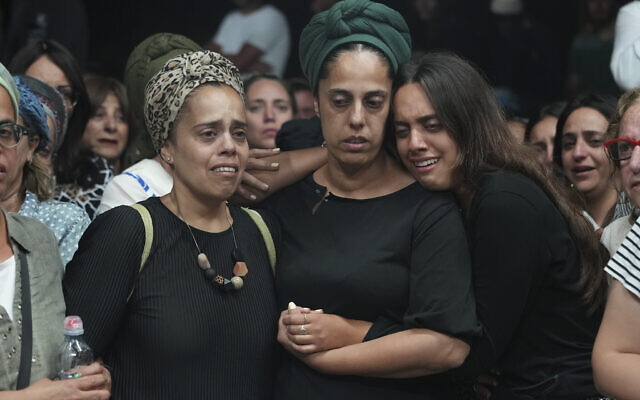 Relatives of Harel Masood, 21, who was killed in a terror attack near the West Bank settlement of Eli, mourn during his funeral in Yesodot, June 20, 2023. (AP Photo/Tsafrir Abayov)