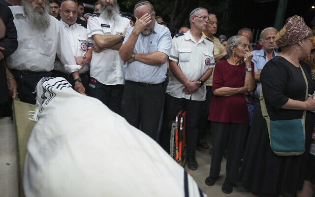 Mourners carry the body of terror victim Harel Masood, 21, during his funeral in Yesodot, June 20, 2023 (AP Photo/Tsafrir Abayov)