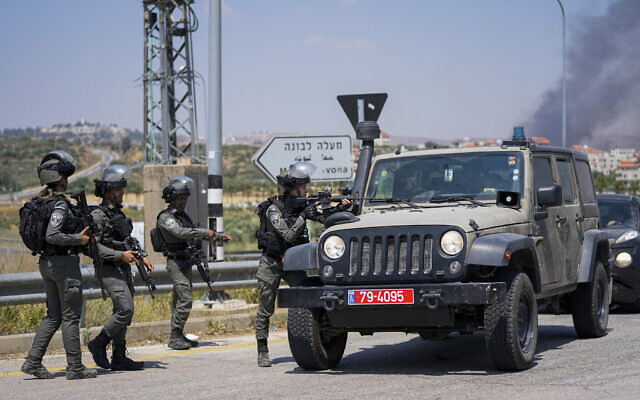 Israeli border police officers are seen on a main road next to the West Bank town of Turmus Ayya, Wednesday, June 21, 2023. (AP Photo/Ohad Zwigenberg)