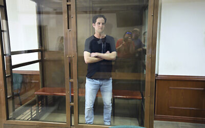 Wall Street Journal reporter Evan Gershkovich stands in a glass cage in a courtroom at the Moscow City Court in Moscow, Russia, Thursday, June 22, 2023. (AP/Dmitry Serebryakov)