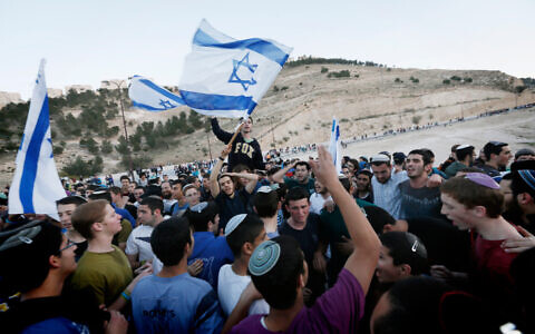 Israelis settlers and right wing activists participate in a march in the area known as E1 close to the Israeli West Bank settlement of Ma'ale Adumim in protest at Prime Minister Benjamin Netanyahu's decision to block construction there, February 13, 2014. (Miriam Alster/FLASH90)