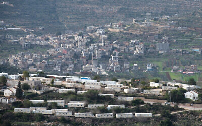 A neighborhood in the West Bank settlement of Eli overlooking a nearby Palestinian village, January 17, 2021. (Sraya Diamant/Flash90)