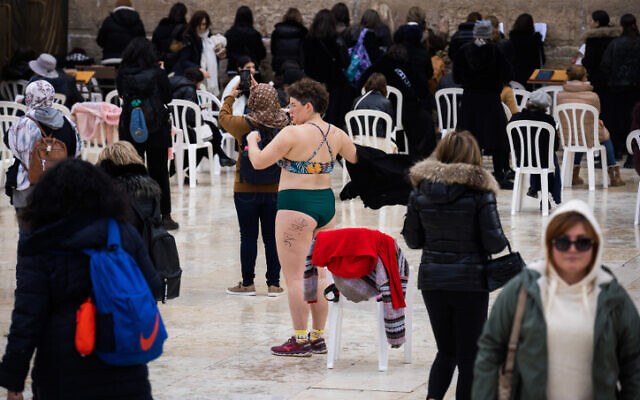 An activist wears a swimsuit in the women's section at the Western Wall in Jerusalem, as part of a protest against a bill proposed by the Shas party, February 12, 2023. (Oren Ziv/Flash90)