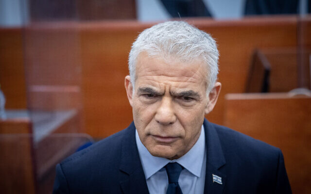 The head of the opposition MK Yair Lapid arrives to testify in the trial against Prime Minister Benjamin Netanyahu at the District Court in Jerusalem on June 12, 2023. (Yonatan Sindel/Flash90)
