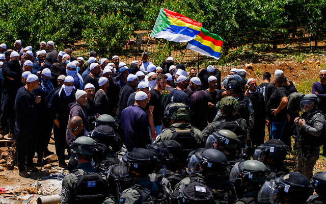 Druze face off against police during a protest against the construction of a new wind farm near the Druze village of Majdal Shams, in the Golan Heights, June 20, 2023. (Ayal Margolin/Flash90)