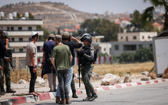 IDF soldiers and settlers at the entrance to the West Bank village of Turmus Ayya, June 21, 2023 (Yonatan Sindel/FLASH90)