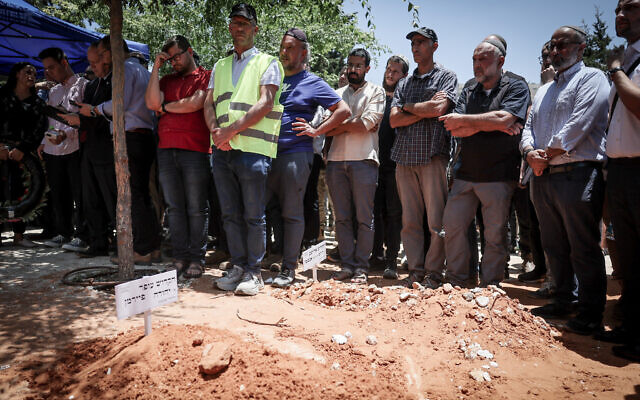 Friends and family attend the funeral of 64-year-old Ofer Fayerman, who was killed in a terror attack near the West Bank settlement of Eli, at the cemetery in Eli, on June 21, 2023. (Yonatan Sindel/Flash90)
