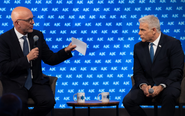 The CEO of the American Jewish Committee, Ted Deutch, left, interviews Israeli opposition leader Yair Lapid on June 11, 2023, in Tel Aviv, Israel. (Courtesy of AJC)