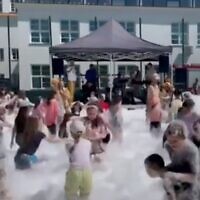 Children enjoy a bubble party in Kazimierz Dolny, Poland, for Children's Day, June 1, 2023. (Screenshot from YouTube/Kan via JTA)