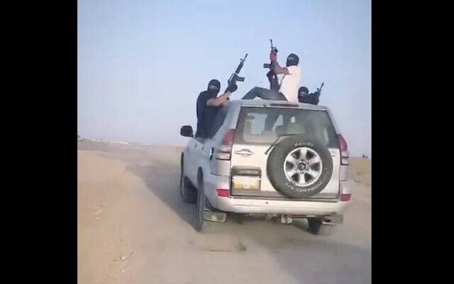 A screenshot from video of masked suspects firing into the air during a wedding procession in the southern Bedouin town of Tel Sheva, June 16, 2023. (Screenshot: Twitter; used in accordance with Clause 27a of the Copyright Law)