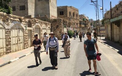 Participants on a recent tour of Israel and the West Bank, which included members of Pittsburgh's Congregation Dor Hadash, walk through Hebron. (Courtesy of Shleimut via JTA)