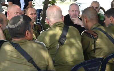 Defense Minister Yoav Gallant speaks with IDF officers during a drill in northern Israel, June 6, 2023. (Ariel Hermoni/Defense Ministry)
