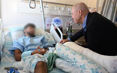 Defense Minister Yoav Gallant visits soldiers injured during an IDF raid of Jenin at Haifa's Rambam Medical Center on June 20, 2023. (Nicole Laskavi/Defense Ministry)