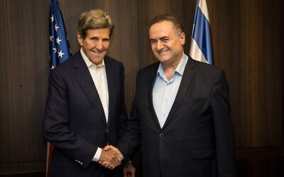 US climate envoy John Kerry (left) and Energy Minister Israel Katz shake hands at a meeting in Jerusalem, June 2, 2023. (Oded Karni)