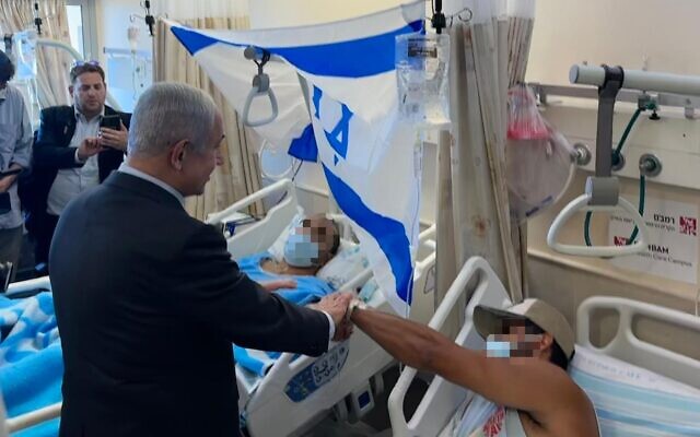 Prime Minister Benjamin Netanyahu visits soldiers injured during an IDF raid of Jenin at Haifa's Rambam Medical Center on June 19, 2023. (Kobi Gideon/GPO)