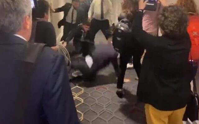 A security guard with Economy Minister Nir Barkat throws a protestor to the ground, in Boston on June 8, 2023.  (Screenshot via Twitter used in accordance with clause 27a of the Copyright Law).