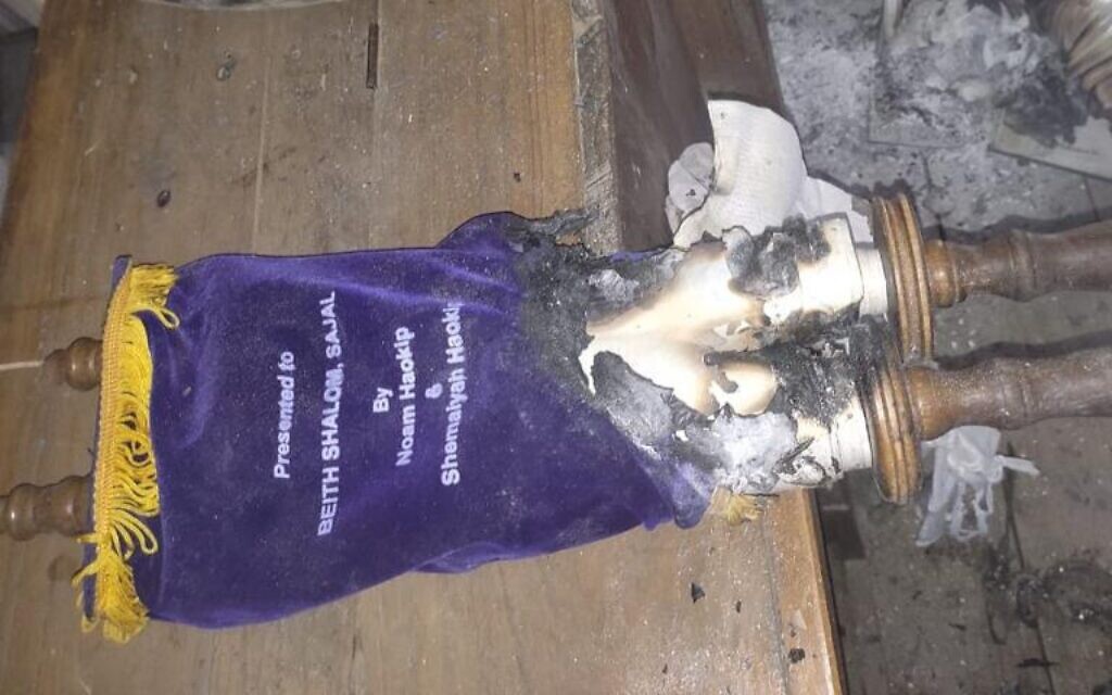 Two of the community's synagogues have burned down and another Torah scroll was torched. (Shavei Israel via JTA)