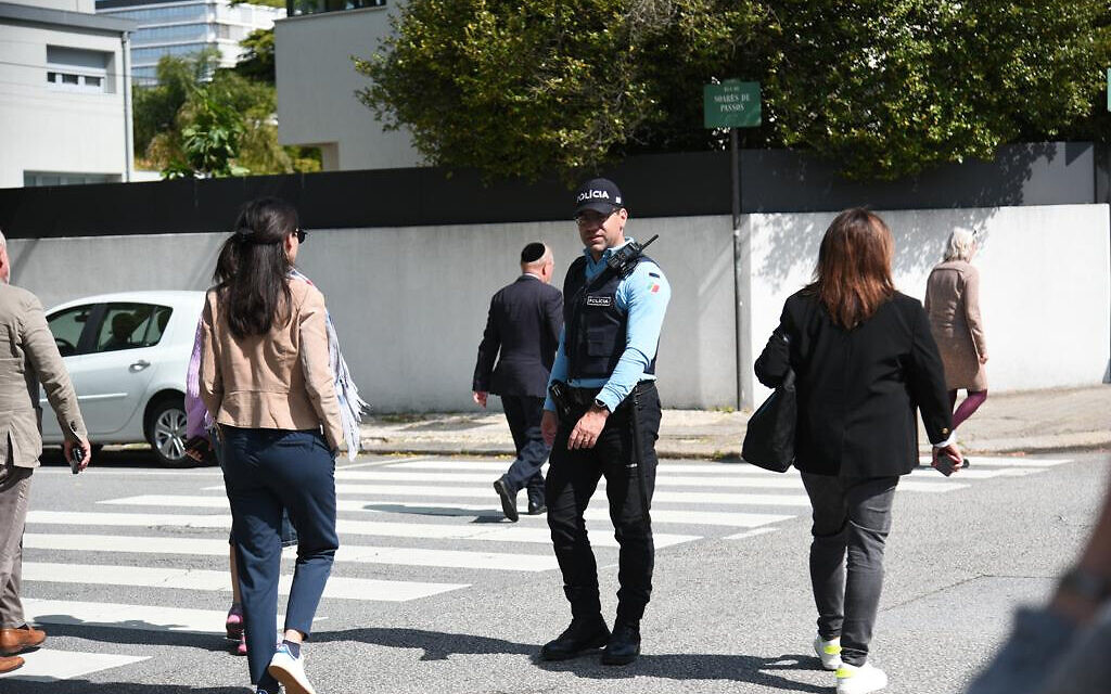 A police officer blocks a road for visitors of the Kadoorie Synagogue in Porto, Portugal on May 16, 2023. (Eli Mandelbaum/EJA)