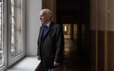 Reuven Shvartsman looks out a window of his apartment building in Odesa, Ukraine, in February 2023. (Courtesy of IFCJ)