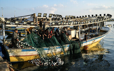 Illustrative: Palestinian fishermen work at the port in Gaza City, June 15, 2023. (RONALDO SCHEMIDT/AFP)