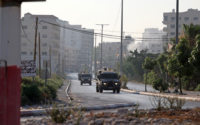 Israeli armored vehicles drive through the West Bank city of Jenin on July 3, 2023, after an Israeli strike. (Jaafar ASHTIYEH / AFP)