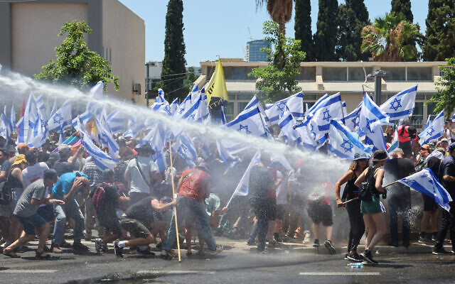 A police water cannon fires on anti-overhaul protesters in Tel Aviv, on July 11, 2023. (JACK GUEZ / AFP)