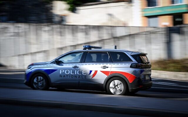 A police car drives down the street in Lyon, eastern France, on July 16, 2023. (OLIVIER CHASSIGNOLE / AFP)