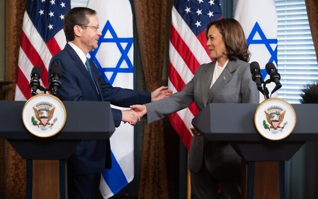 US Vice President Kamala Harris shakes hands with President Isaac Herzog as they speak to the media prior to a meeting at the Eisenhower Executive Office Building in Washington, July 19, 2023. (SAUL LOEB / AFP/File)