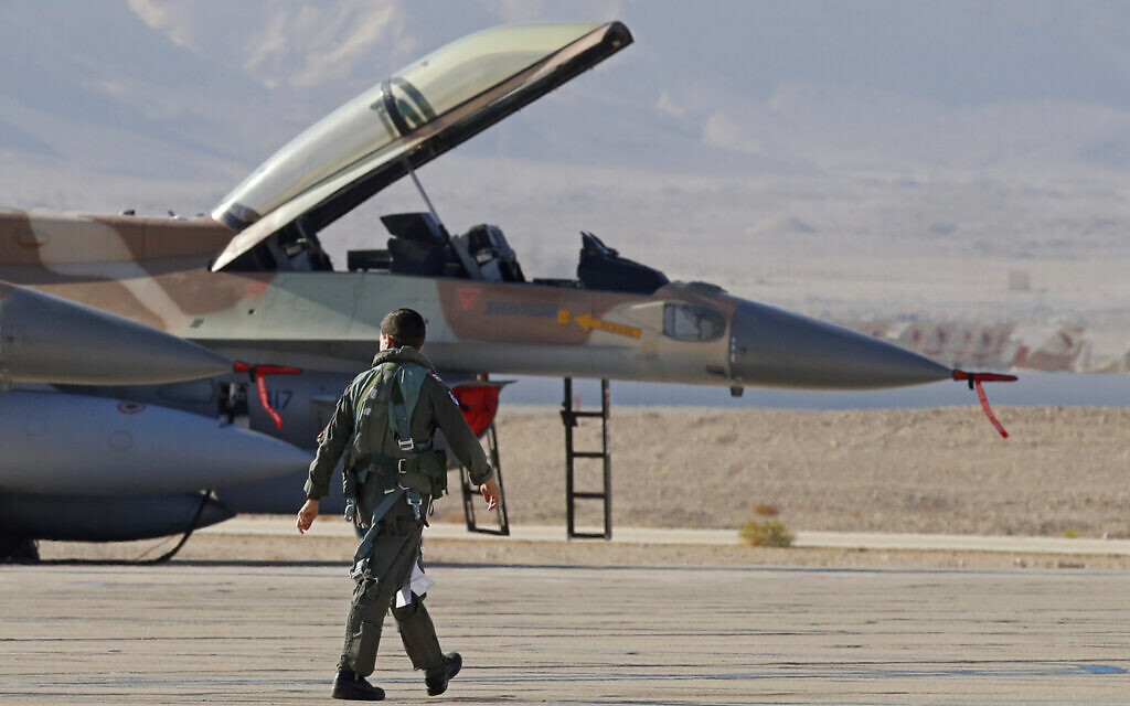 File: An Israeli Air Force pilot walks to his F-16 fighter jet during the "Blue Flag" multinational air defense exercise at the Ovda air force base, on October 24, 2021. (JACK GUEZ / AFP)