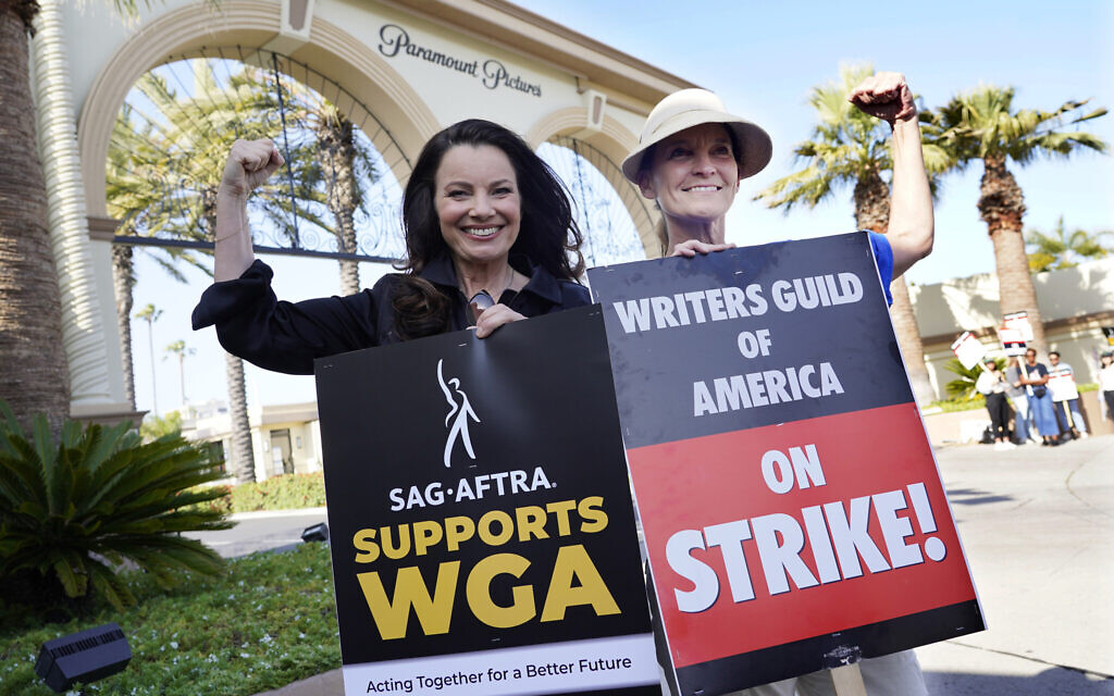 Fran Drescher, left, president of SAG-AFTRA, and Meredith Stiehm, president of Writers Guild of America West, pose together during a rally by striking writers outside Paramount Pictures studio, Monday, May 8, 2023, in Los Angeles. (AP Photo/Chris Pizzello)